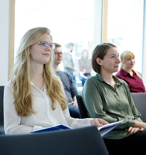 A woman sitting on a chair during a meeting 